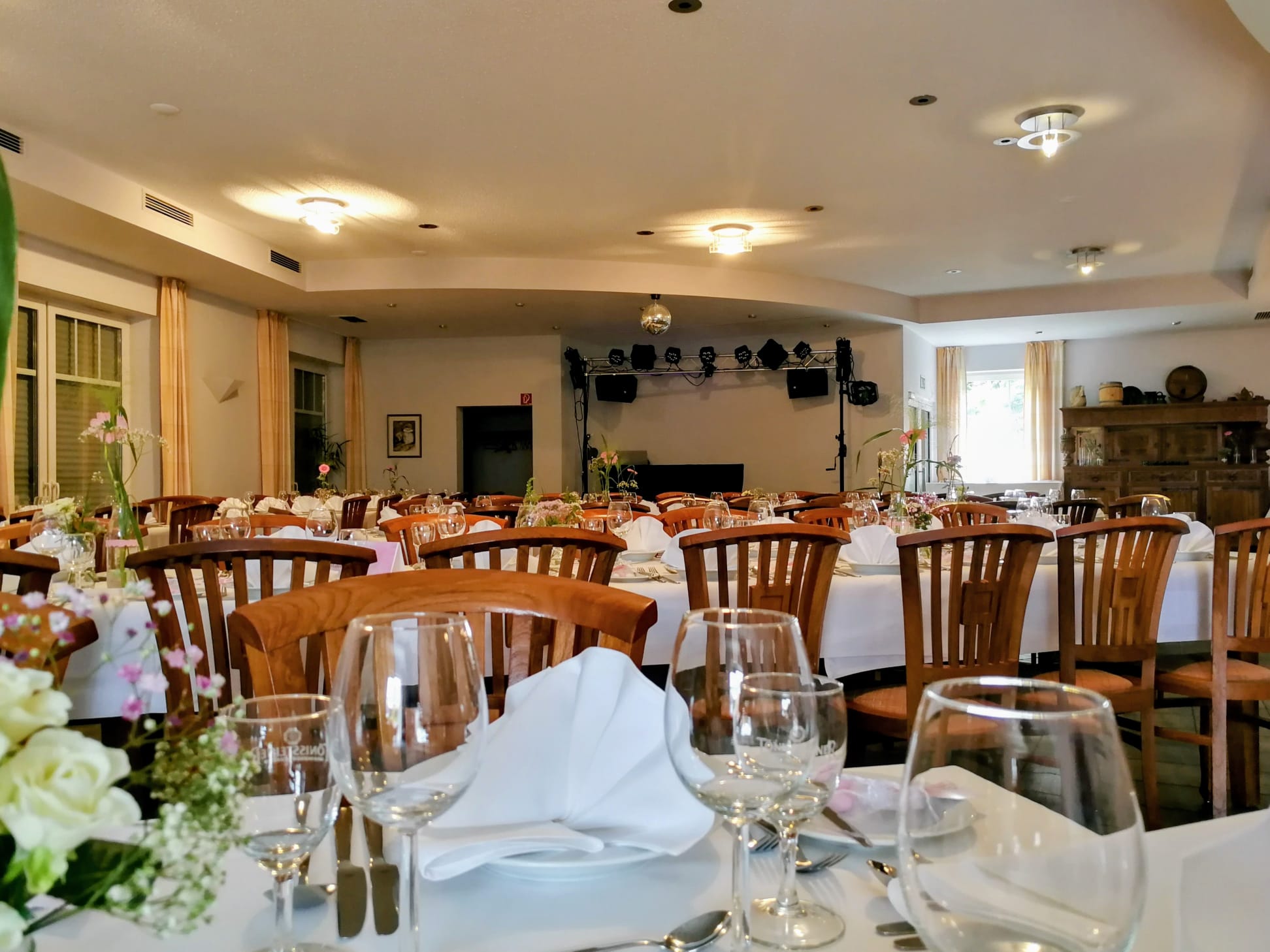Gedeckte Tafeln im Saal